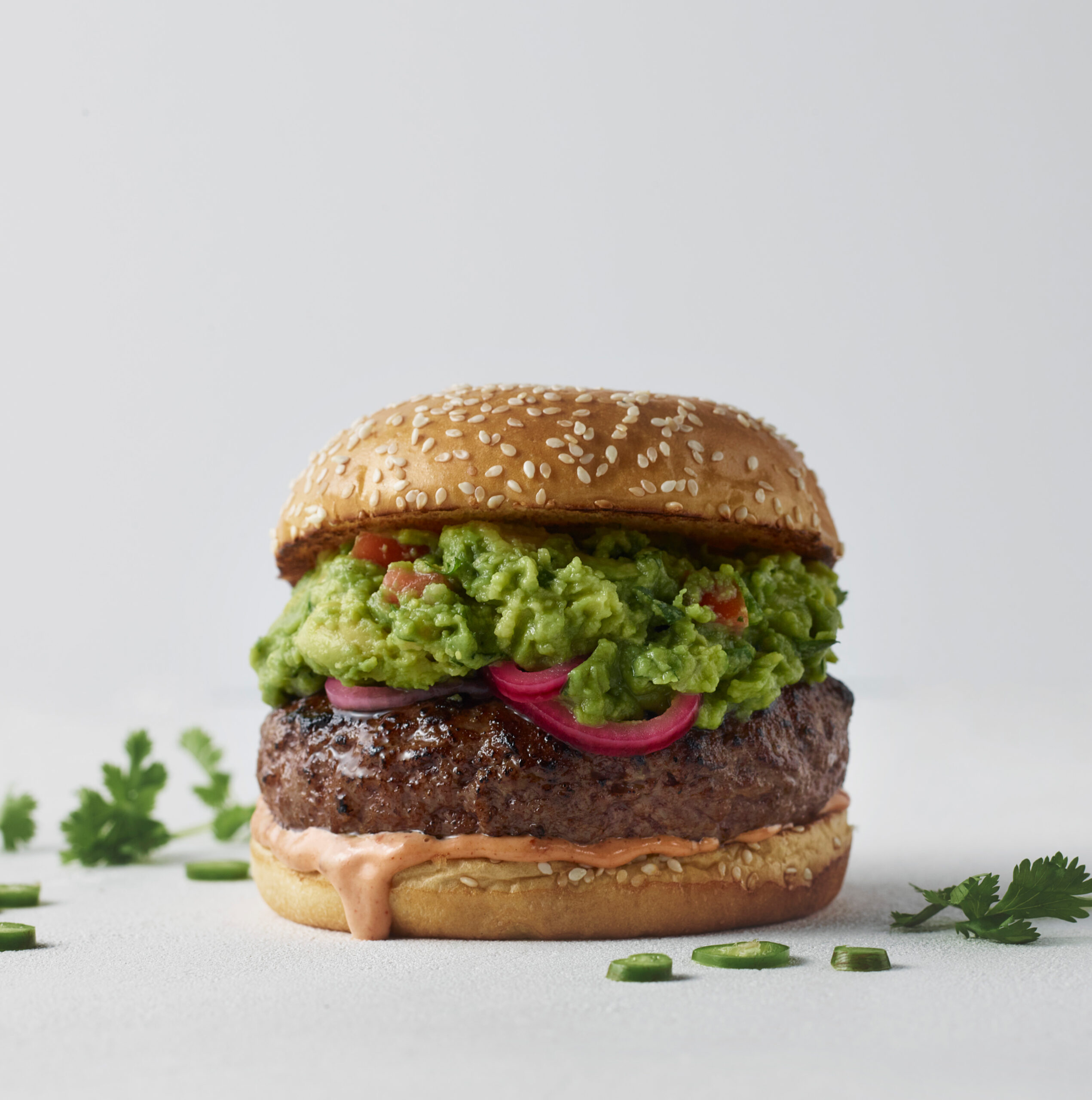 Cheeseburger topped with WHOLLY guacamole