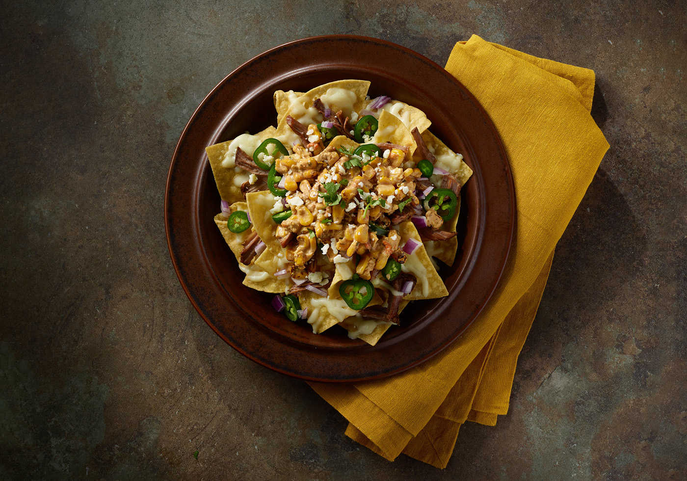 Top down view of Nachos with HERDEZ® Mexican Street Corn as a topping.